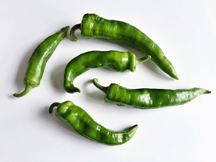 Close-up of green chili peppers on table