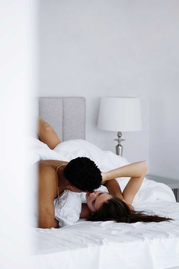 Young couple lying on bed at home