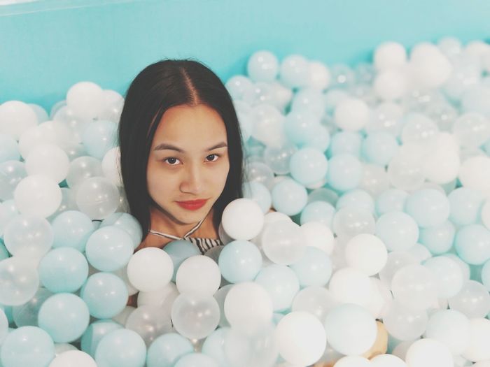 Portrait of young woman in ball pool