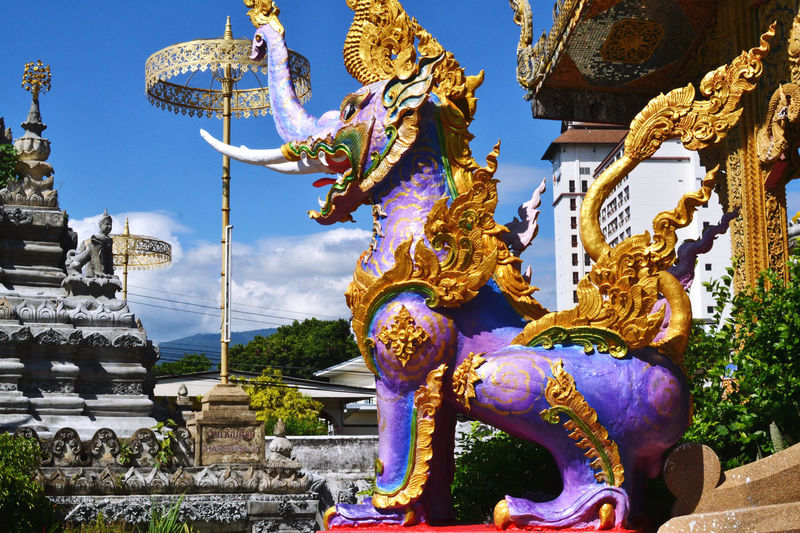 Statue of temple against building