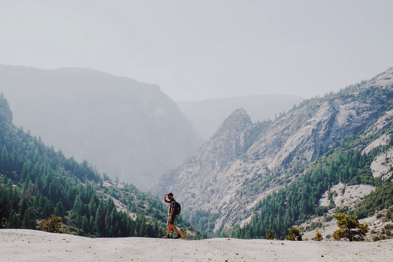 Man standing on mountain against clear sky