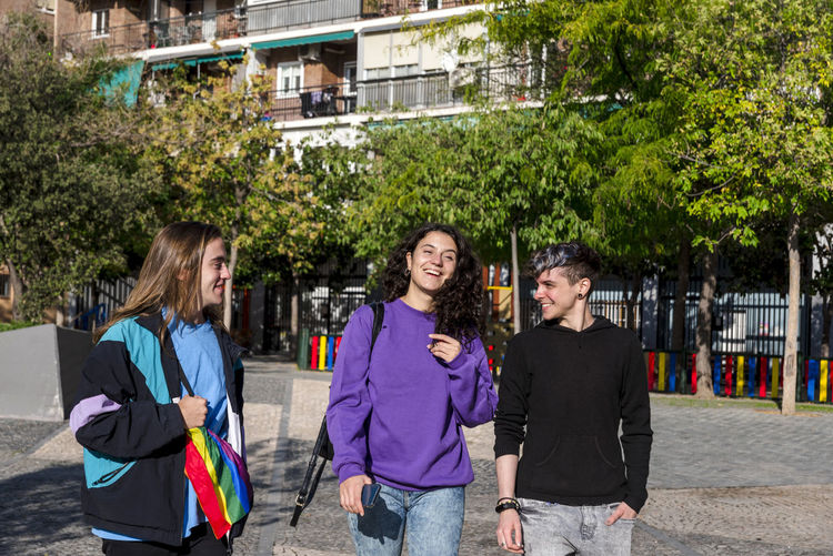 Portrait of smiling friends standing on street