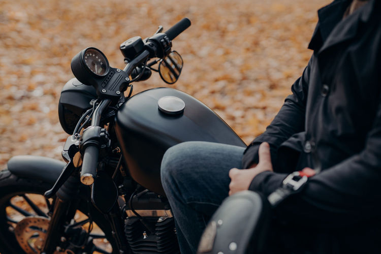 Midsection of man sitting on motorcycle