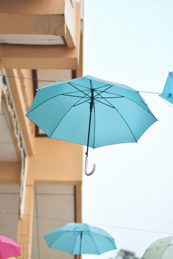 Close-up of umbrella against sky during rainy season