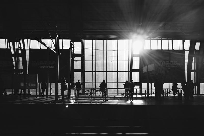 Silhouette people walking on railroad station platform