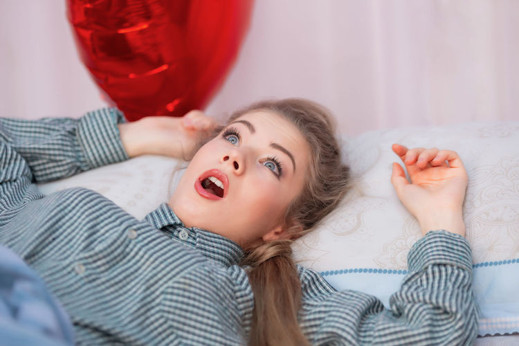 Midsection of woman lying on bed