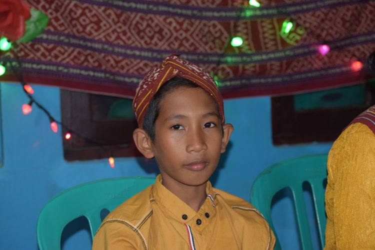 Portrait of young man standing in temple