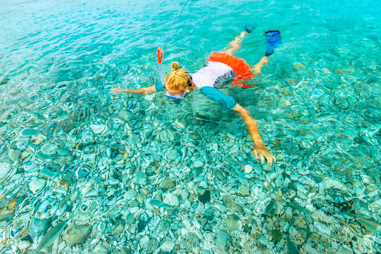 High angle view of woman swimming in sea