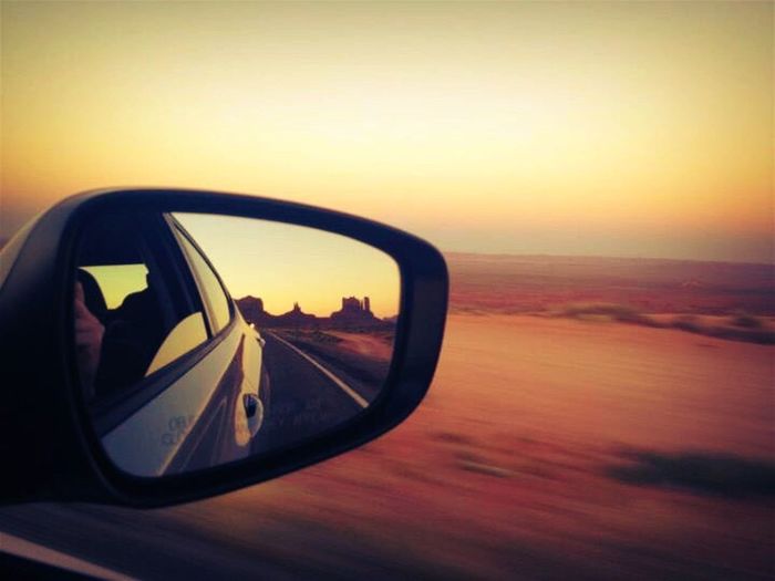 Reflection of side-view mirror at sunset