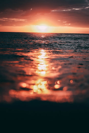 Scenic view of sea against romantic sky at sunset