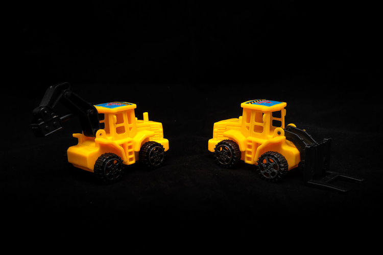 Close-up of yellow toy car against black background