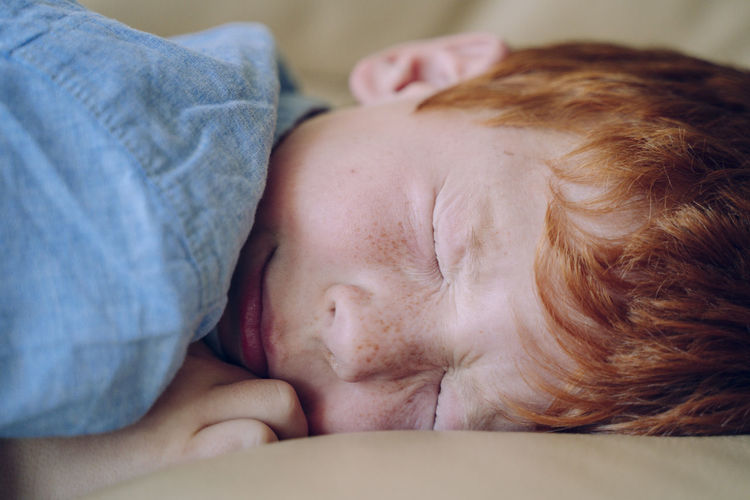 Close-up of boy sleeping on sofa