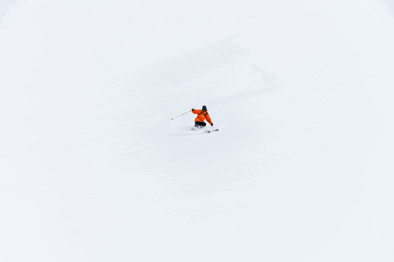 Low angle view of people skiing on snow