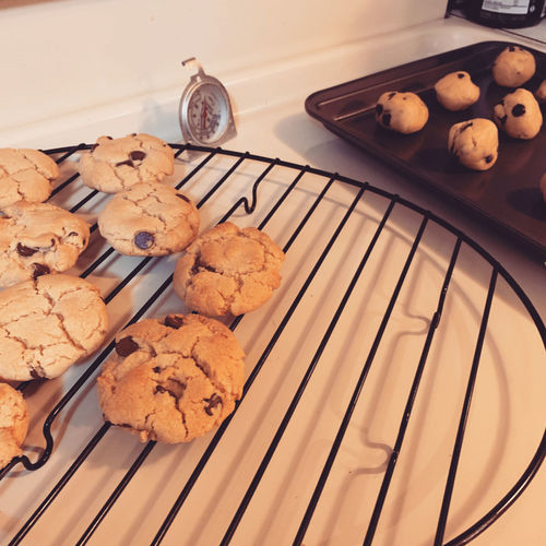 High angle view of cookies in plate on table cooling rack stove