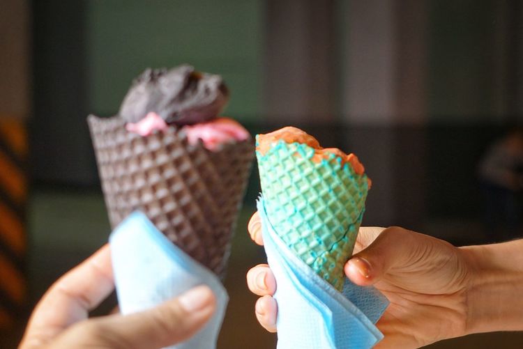 Cropped image of people holding ice cream