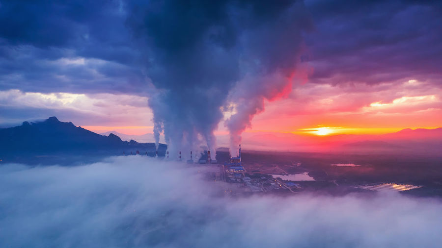 Aerial view coal power plant station in the morning mist, the morning sun rises. mae moh, lampang, 
