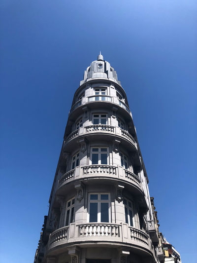 Low angle view of building against clear blue sky