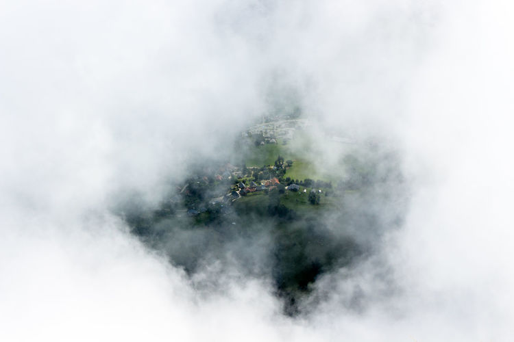 High angle view of village seen through cloud
