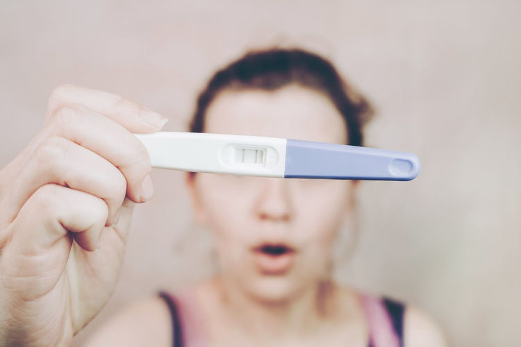 Close-up of woman hand holding pregnancy test