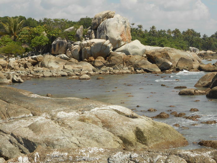 Rocks on beach against sky