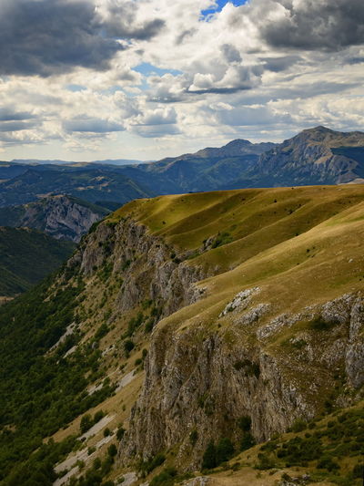 Scenic view of valley and mountains against sky