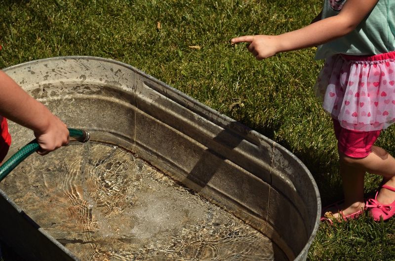 Cropped image of siblings in back yard
