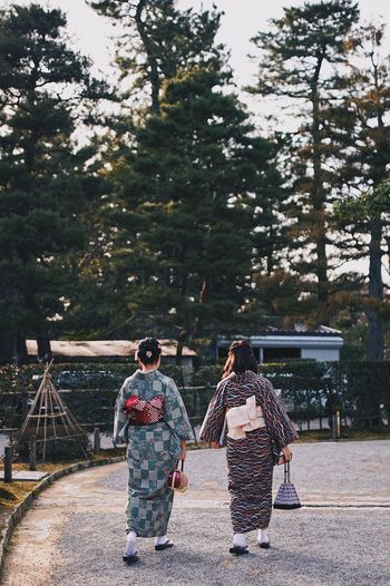 Rear view of women in kimonos walking on street