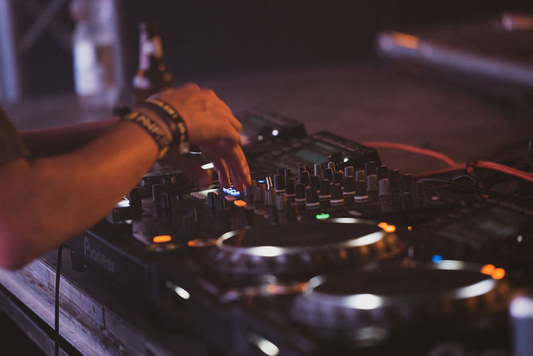 Cropped of hand playing turntable at concert