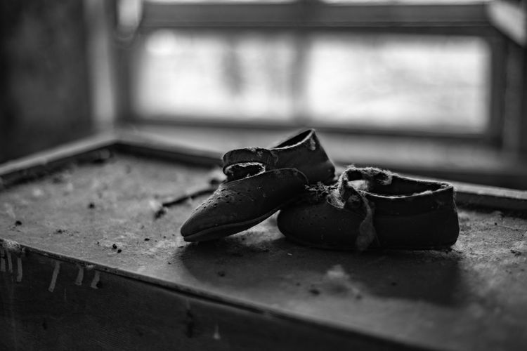 Close-up of child's shoes on  table in pripyat 