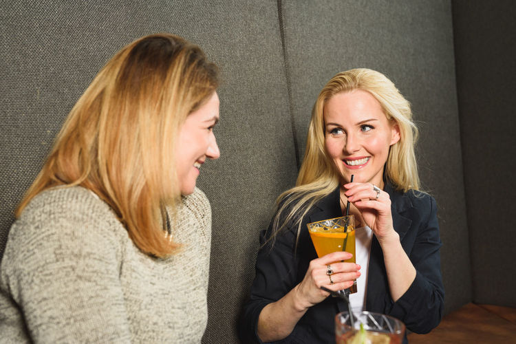 Adult woman resting with friend in bar