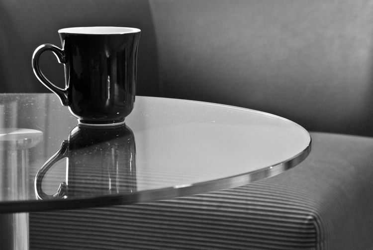 Close-up of coffee cup on table at home
