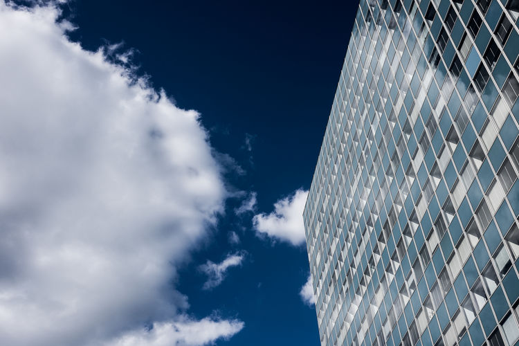 Low angle view of modern office building against sky