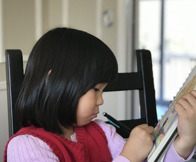 Portrait of a cute girl writing