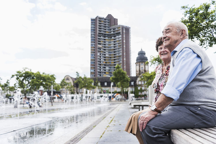 Germany, mannheim, senior couple sitting together on a bench