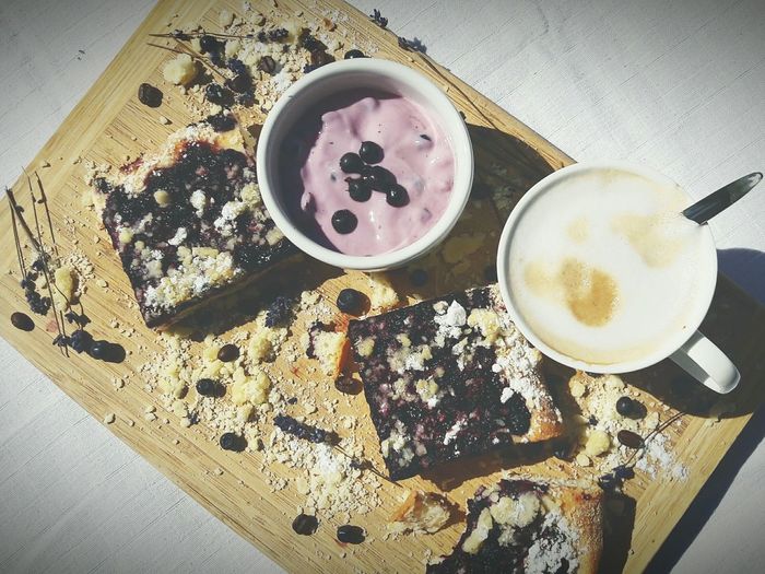 Directly above shot of blueberry dessert with coffee on tray