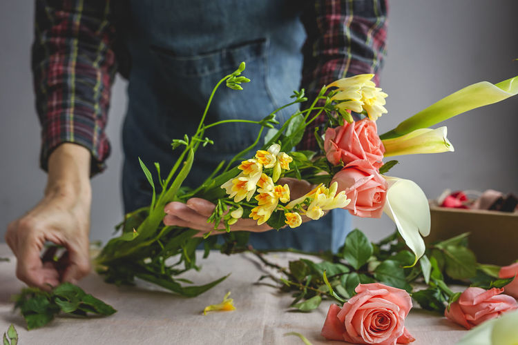 Low section of person holding rose bouquet