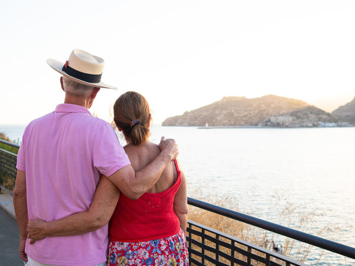 Caucasian elderly couple enjoying the scenery from a harbor lookout po