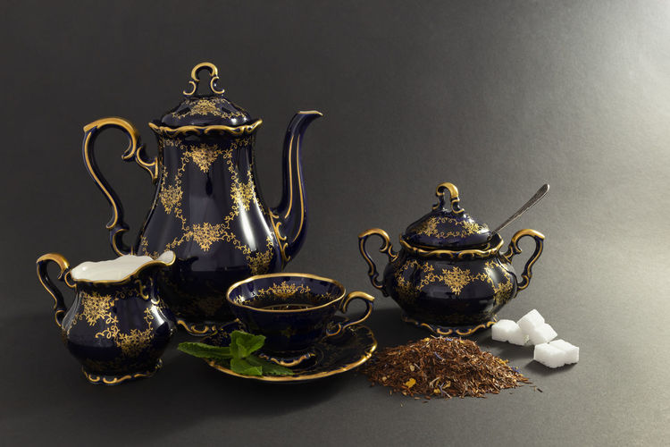 Close-up of tea served on table against black background