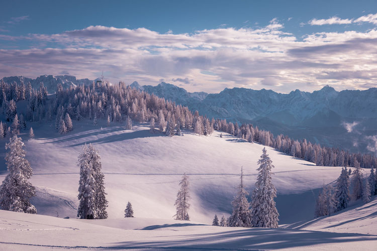 Scenic view of snow covered mountains against sky