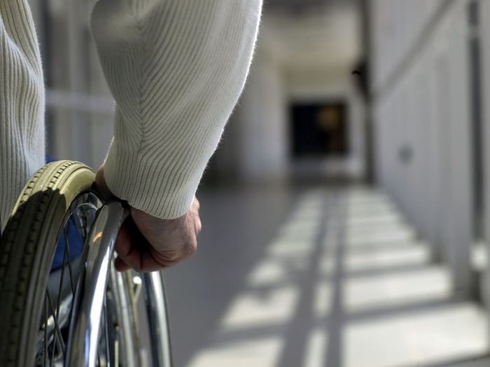 Man on wheelchair in corridor