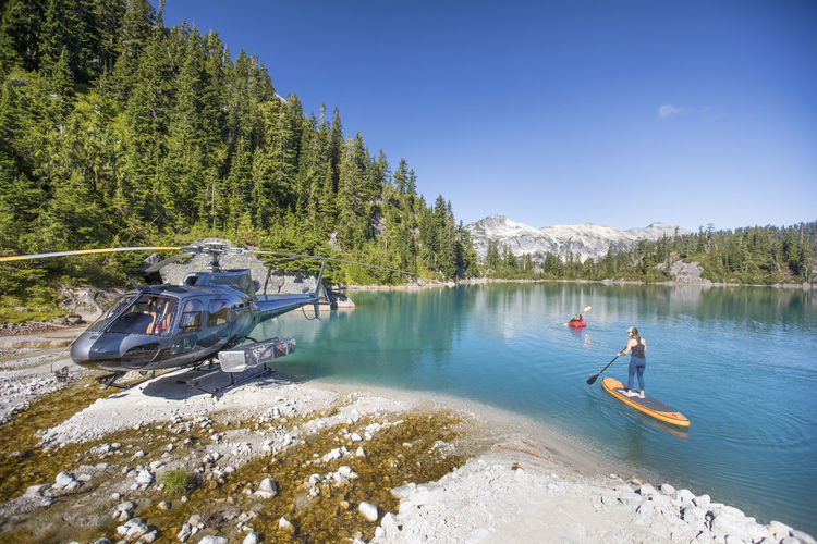 Mother and daughter paddling on stunning blue lake during tour.