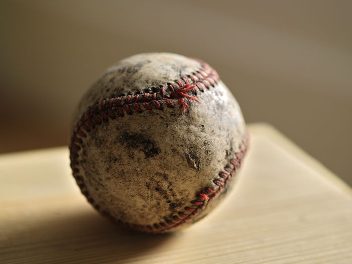 Close-up of damaged baseball on table