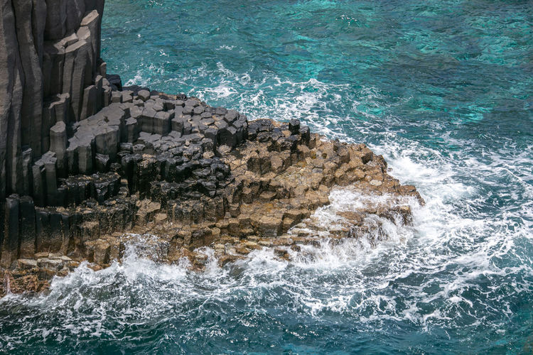 Sea waves splashing on rocks