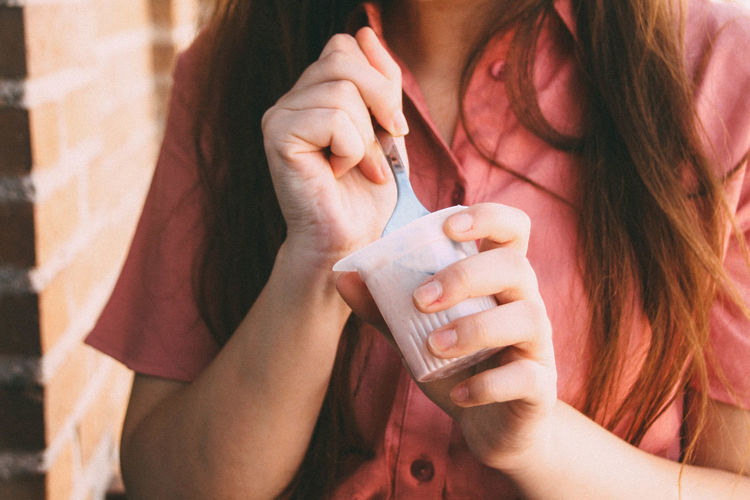 Close-up of woman eating yogurt