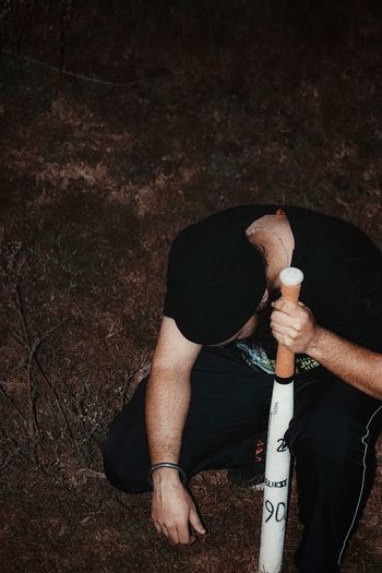 High angle view of man holding ice cream on field
