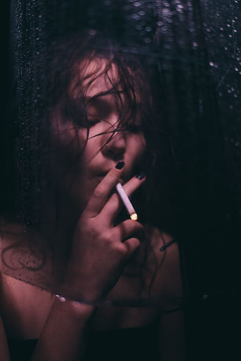 Young woman smoking cigarette