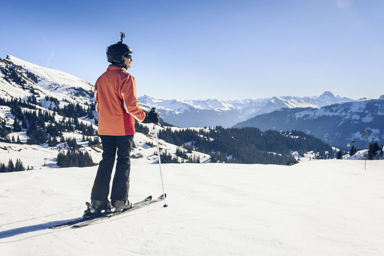 Austria, damuels, skier with action cam in winter landscape