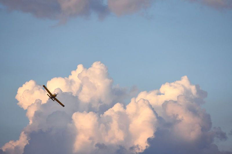 Prarie plane passing through clouds.