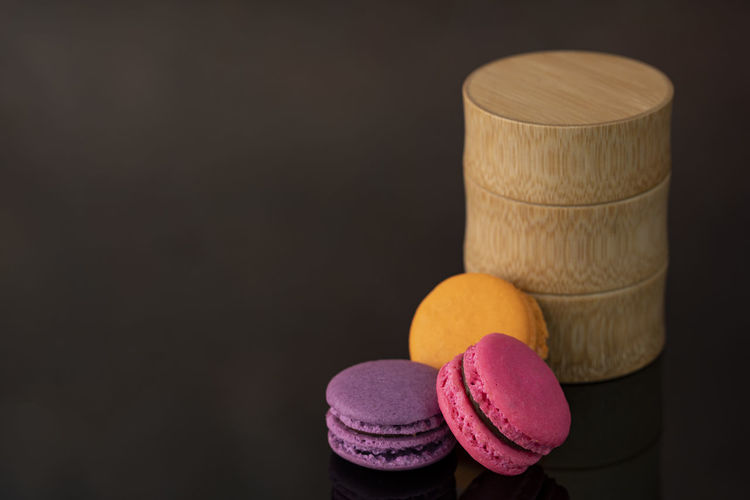 A few delicious macaroon, a famous french dessert with a bamboo container. 