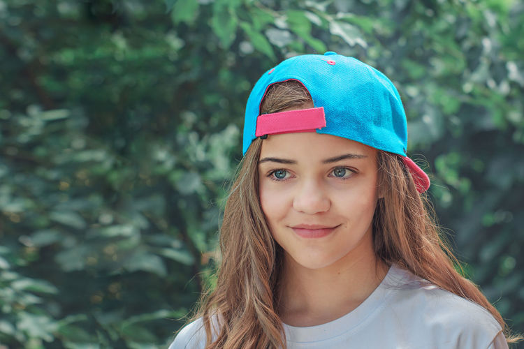 Close-up of teenage girl wearing cap in park
